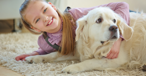 child with pet on the floor