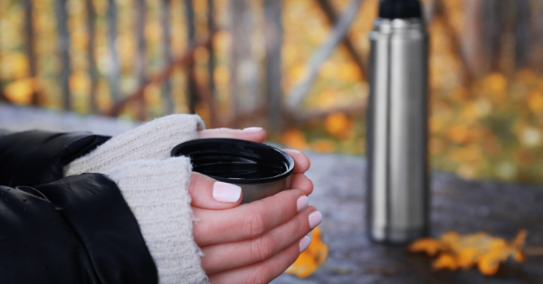 Woman Holding Thermos Cup outside