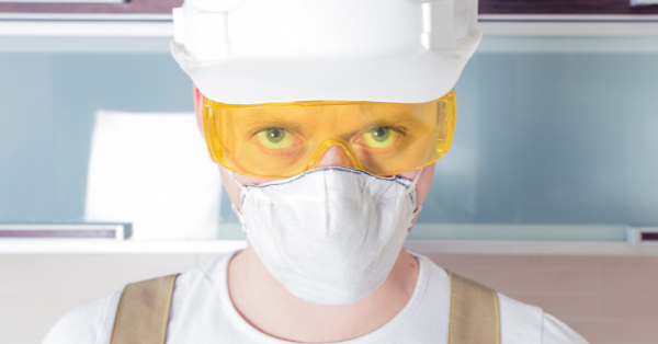 Worker wearing safety glasses respirator helmet
