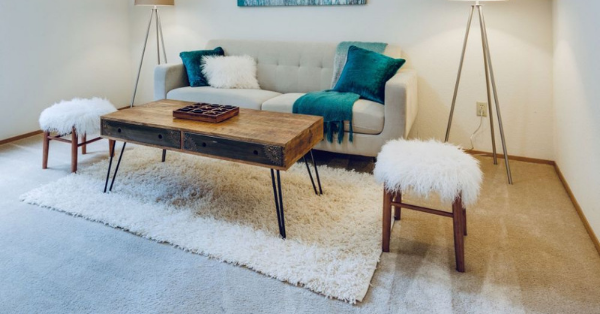 A soft white wool rug placed in a gorgeous living room.