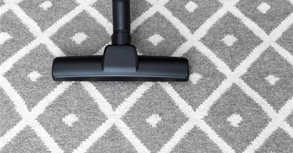 vacuuming the gray carpet