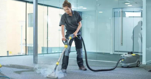 woman cleaning carpet with steam