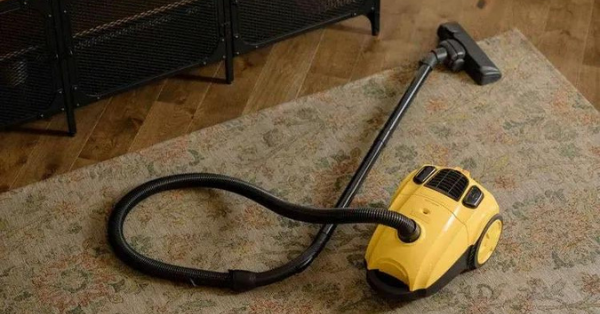 yellow vacuum cleaner on carpet